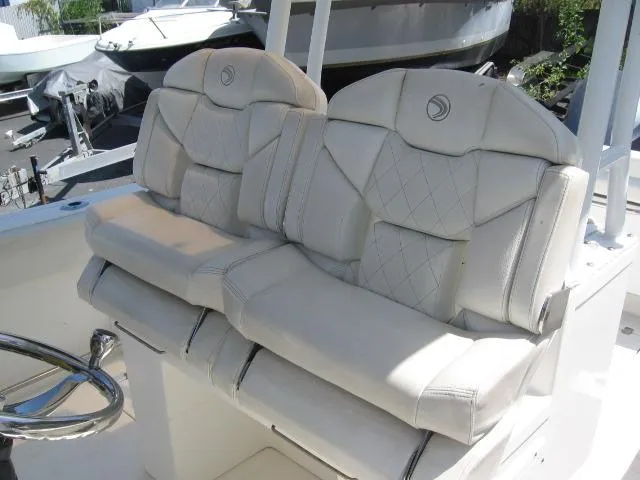 Slide: The Image of 2018 Edgewater 280 CC boat seats with white leather upholstery and diamond stitching. - 11