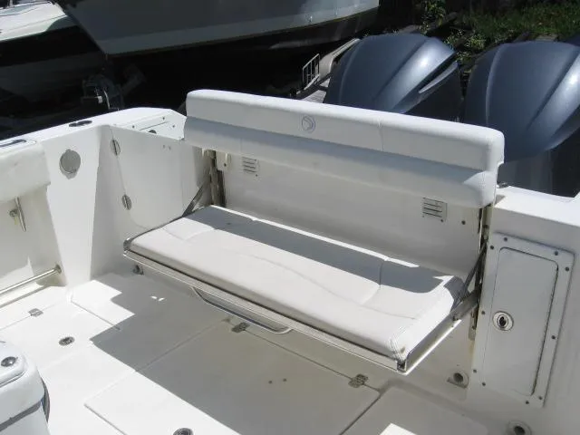 Slide: The Image of 2018 Edgewater 280 CC boat with foldable rear seat and dual engines. - 12