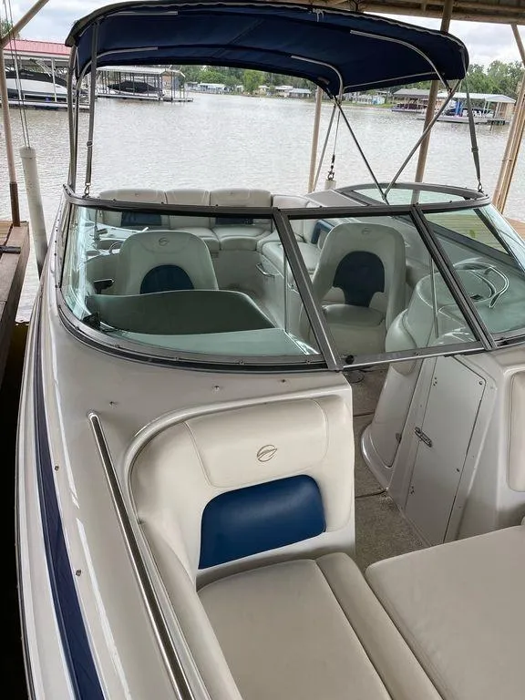Slide: The Image of 2003 Crownline 270 BR boat with canopy, docked by a lake. - 12
