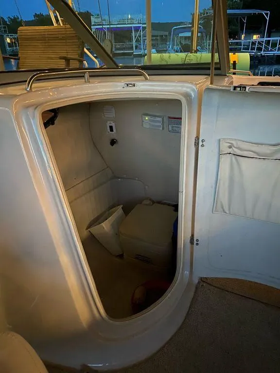Slide: The Image of Interior cabin of 2003 Crownline 270 BR boat, showing storage space and seating. - 14