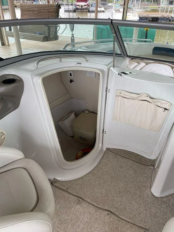 Slide: The Image of 2003 Crownline 270 BR boat interior with open cabin door and seating. - 15