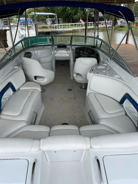 Slide: The Image of 2003 Crownline 270 BR boat interior with white seating and blue accents. - 17