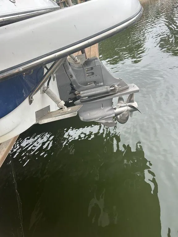 Slide: The Image of 2003 Crownline 270 BR boat stern with propeller in water. - 21