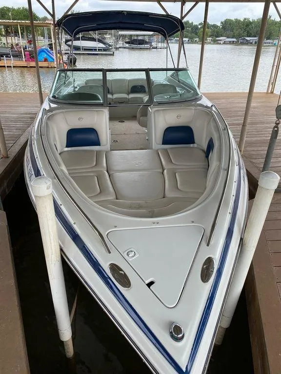 Slide: The Image of 2003 Crownline 270 BR boat docked, featuring spacious seating and sleek design. - 22