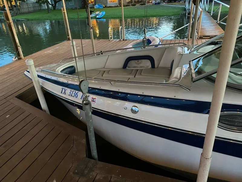 Slide: The Image of 2003 Crownline 270 BR boat docked by a wooden pier. - 24