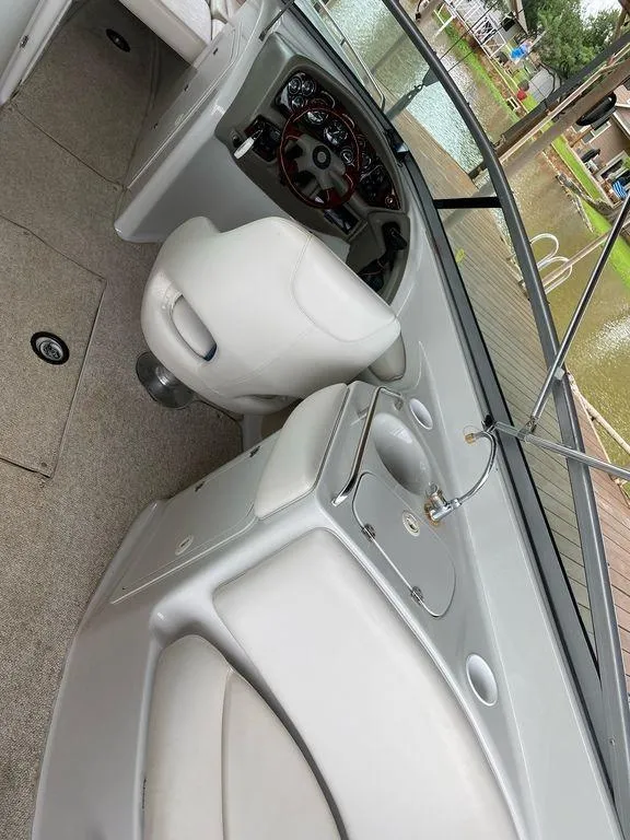 Slide: The Image of 2003 Crownline 270 BR boat interior with steering wheel and seating area. - 27