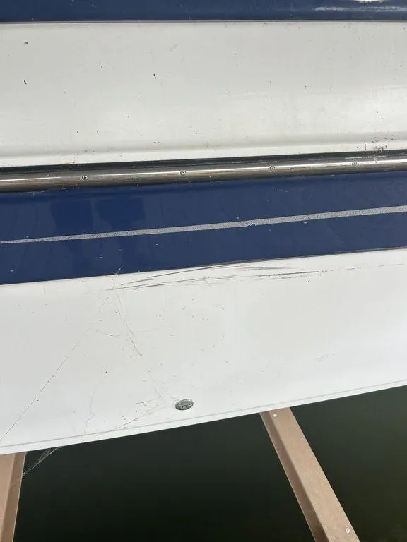 Slide: The Image of 2003 Crownline 270 BR boat hull with blue and white exterior detailing. - 3