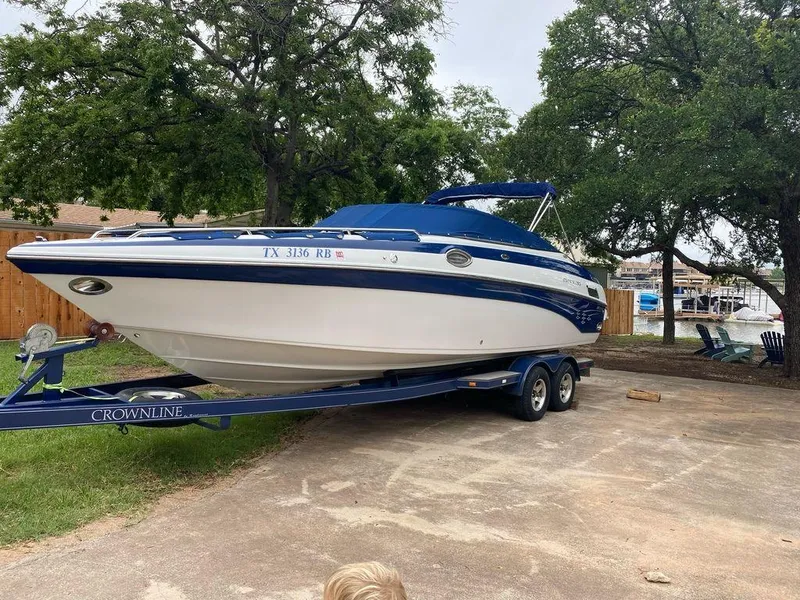 Slide: The Image of 2003 Crownline 270 BR boat on trailer, parked outdoors. - 5
