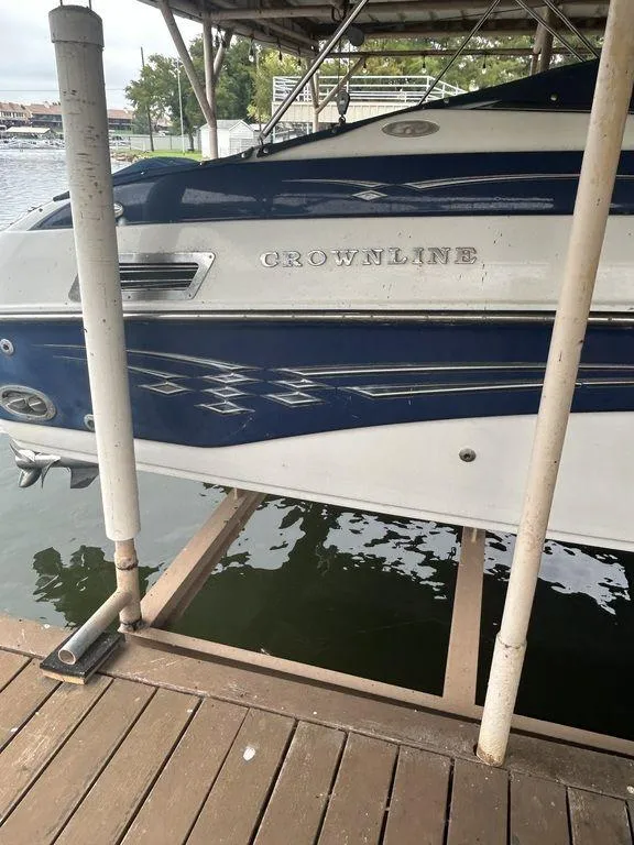 Slide: The Image of 2003 Crownline 270 BR boat docked on a lake. - 7