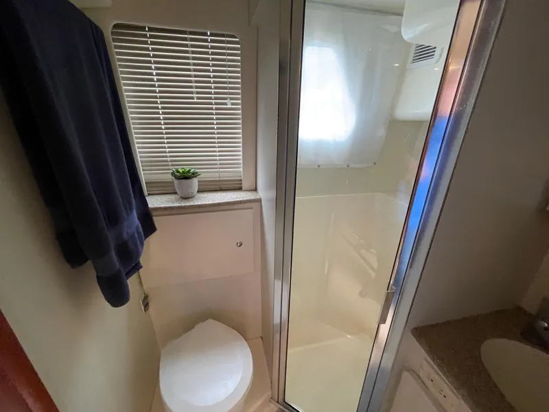 Slide: The Image of 2007 Silverton 330 Sport Bridge bathroom with shower, toilet, and window blinds. - 18