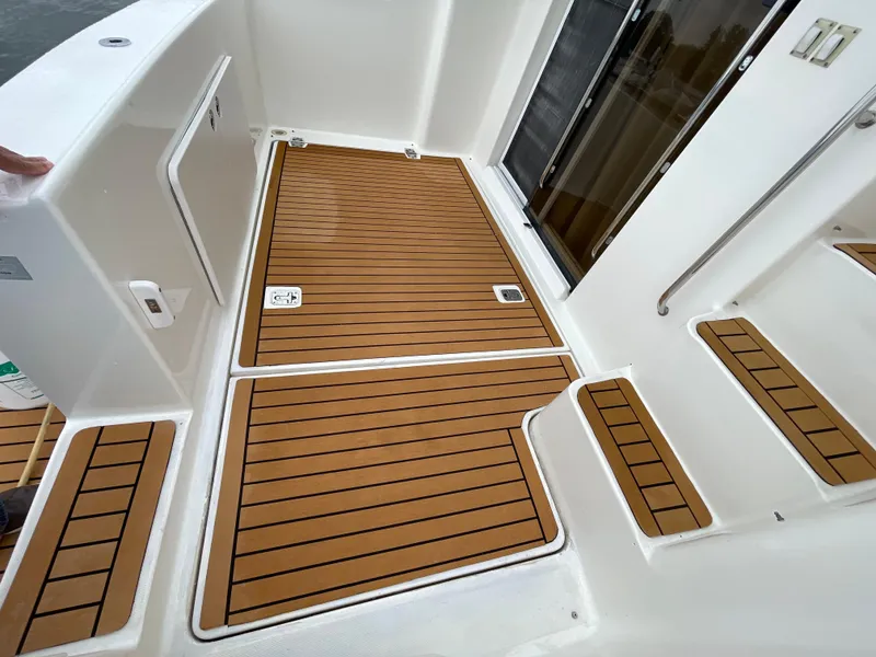 Slide: The Image of 2007 Silverton 330 Sport Bridge deck with teak flooring and white accents. - 3