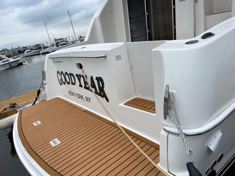 Slide: The Image of 2007 Silverton 330 Sport Bridge docked, featuring teak deck and "Good Year" name. - 4