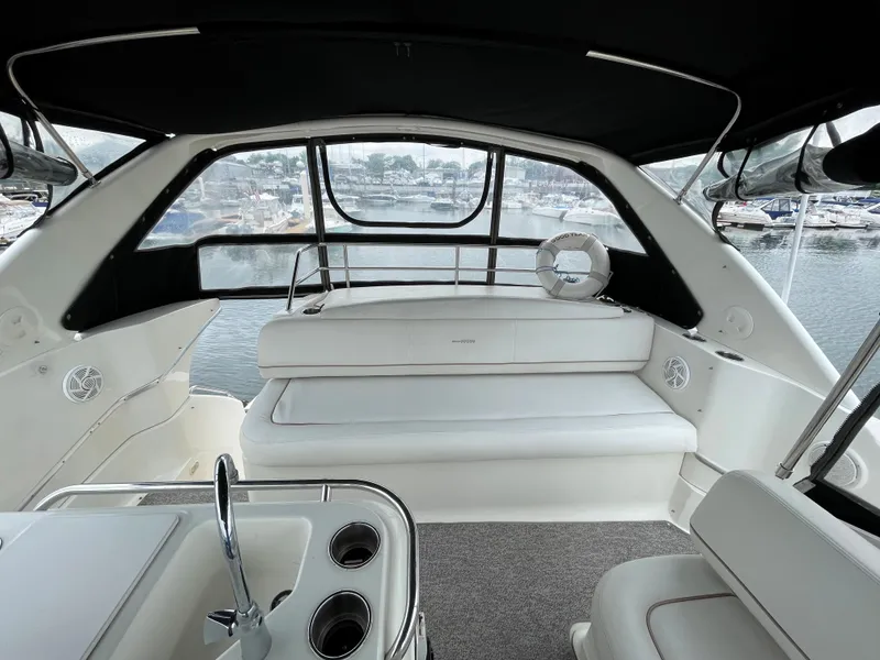 Slide: The Image of 2007 Silverton 330 Sport Bridge interior with seating, windows, and water view. - 8