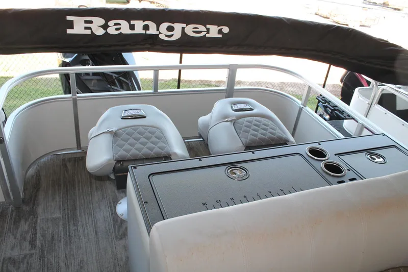 Slide: The Image of 2025 Ranger RP223FC boat interior with cushioned seats and control panel. - 11