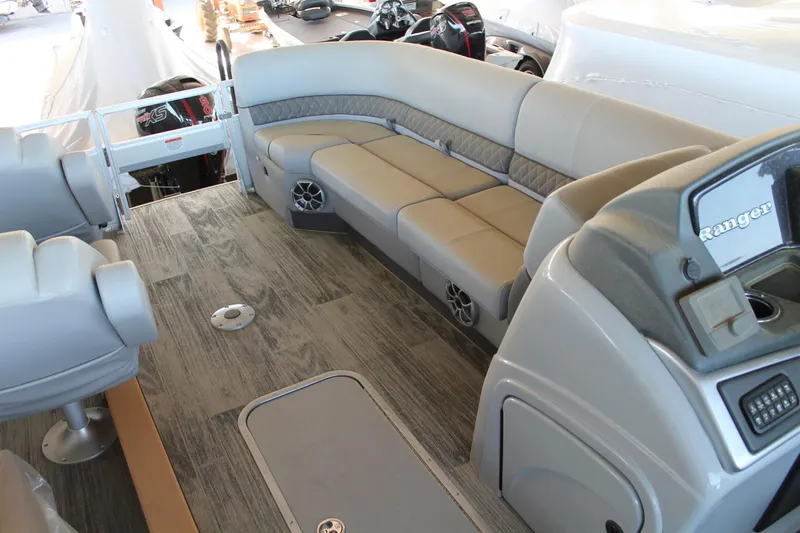 Slide: The Image of 2025 Ranger RP223FC boat interior with gray seating and wood-style flooring. - 13