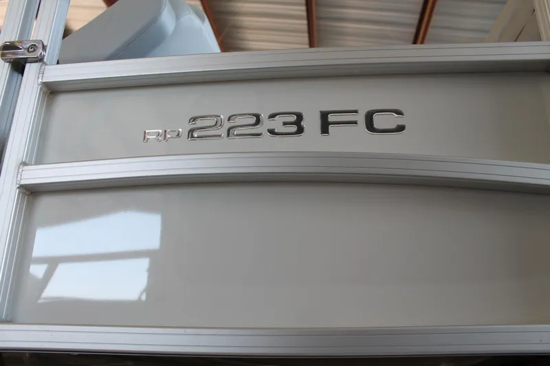 Slide: The Image of 2025 Ranger RP223FC boat model emblem on metallic surface. - 3