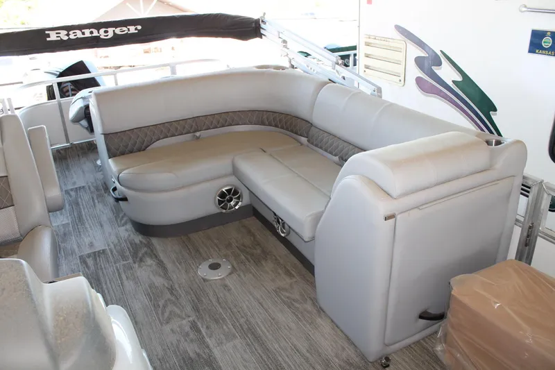 Slide: The Image of 2025 Ranger RP223FC boat interior with gray seating and wood-style flooring. - 7