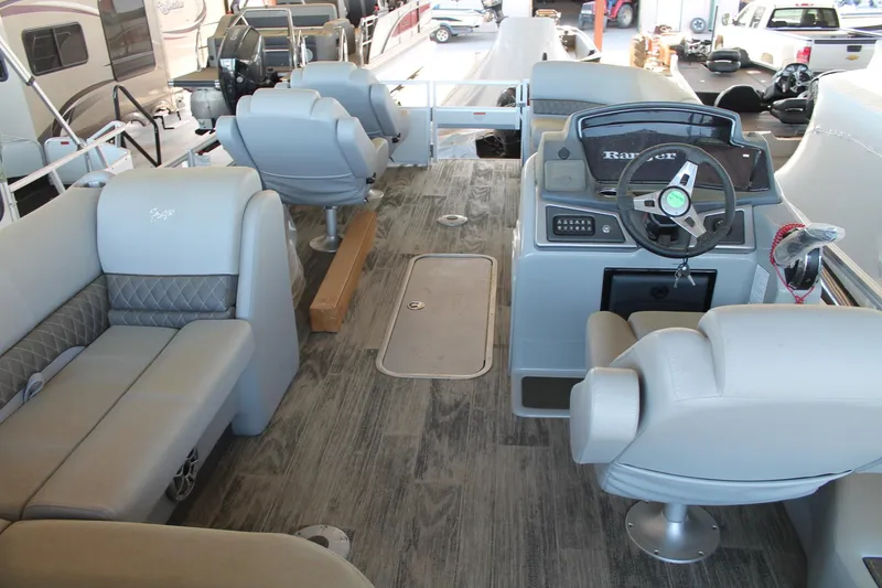 Slide: The Image of 2025 Ranger RP223FC boat interior with gray seating and modern steering console. - 8