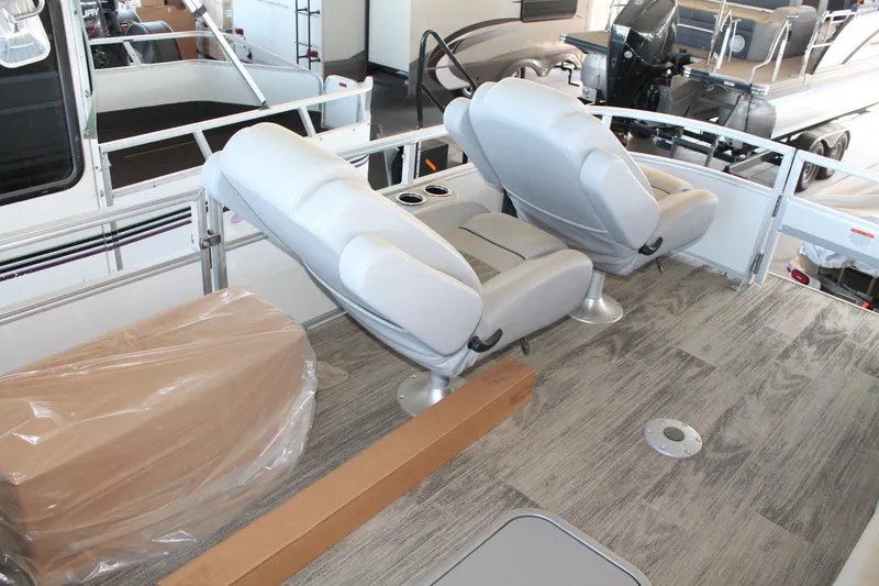 Slide: The Image of Interior of 2025 Ranger RP223FC boat with gray seating and wood-style flooring. - 9