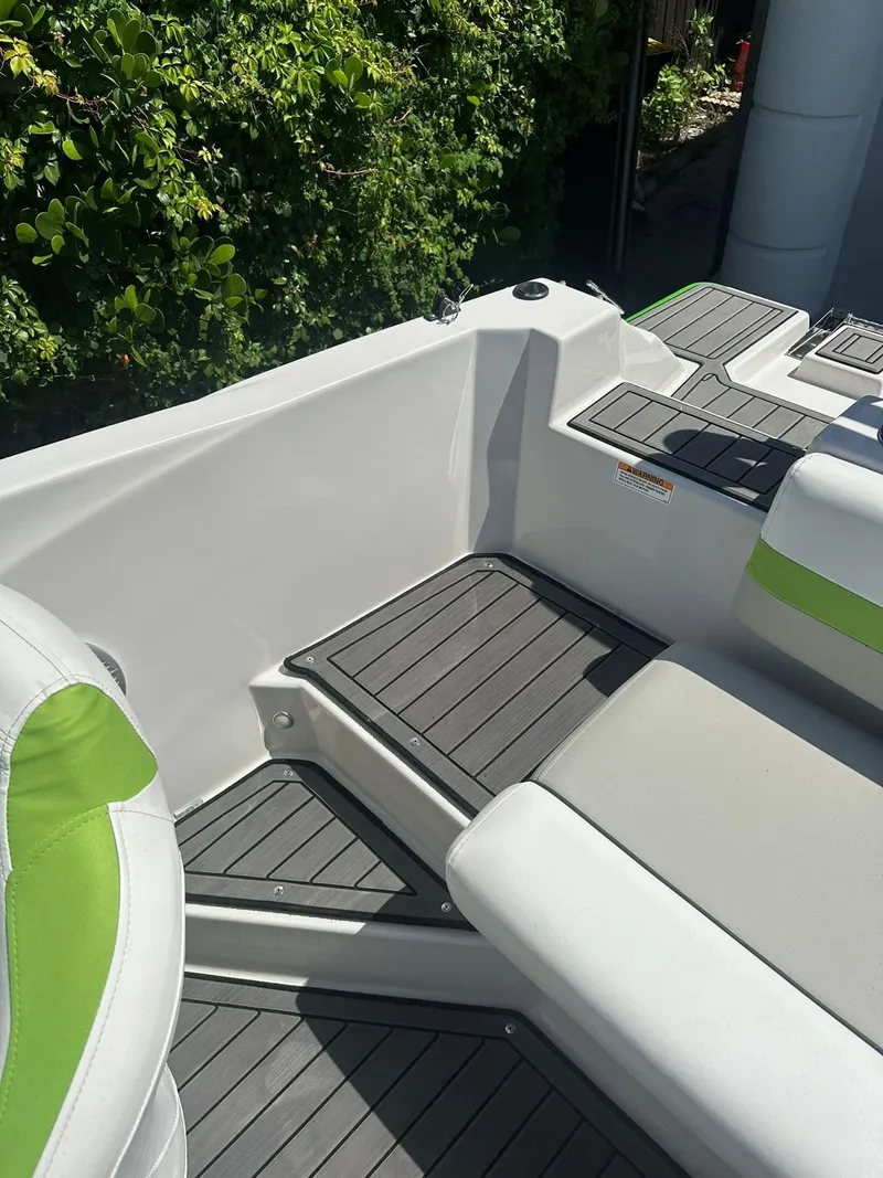 Slide: The Image of 2022 Starcraft SVX 191 OB boat interior with green and white seating. - 17