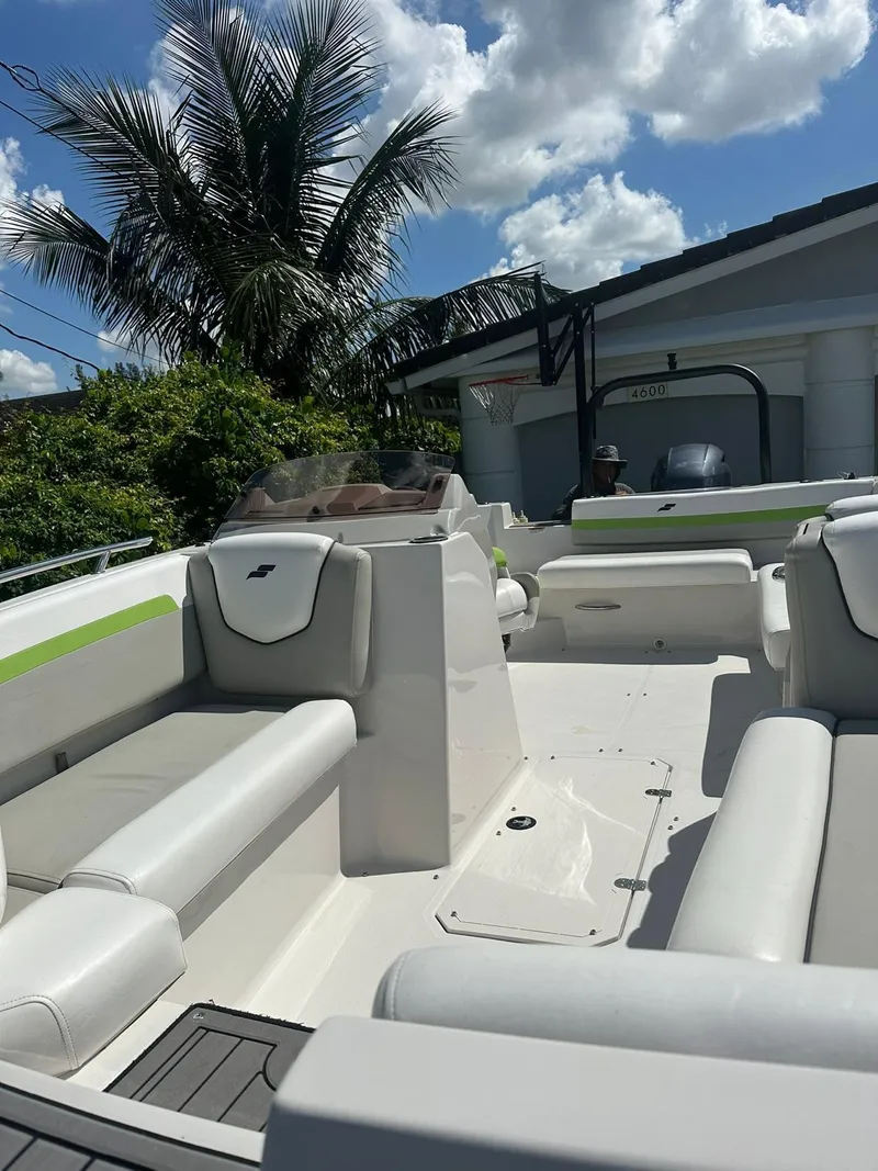 Slide: The Image of 2022 Starcraft SVX 191 OB boat with white seating, under a sunny sky. - 23