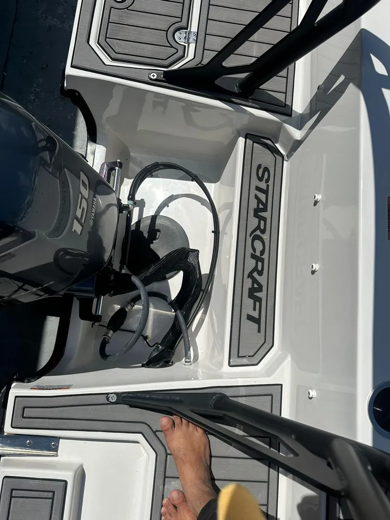 Slide: The Image of 2022 Starcraft SVX 191 OB boat deck with motor and foot visible. - 24