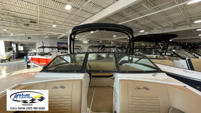 Slide: The Image of 2023 Sea Ray SPX 190 boat displayed in a showroom at Marine Center Indiana. - 11