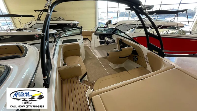 Slide: The Image of 2023 Sea Ray SPX 190 boat interior with tan seating, displayed at Marine Center Indiana. - 18