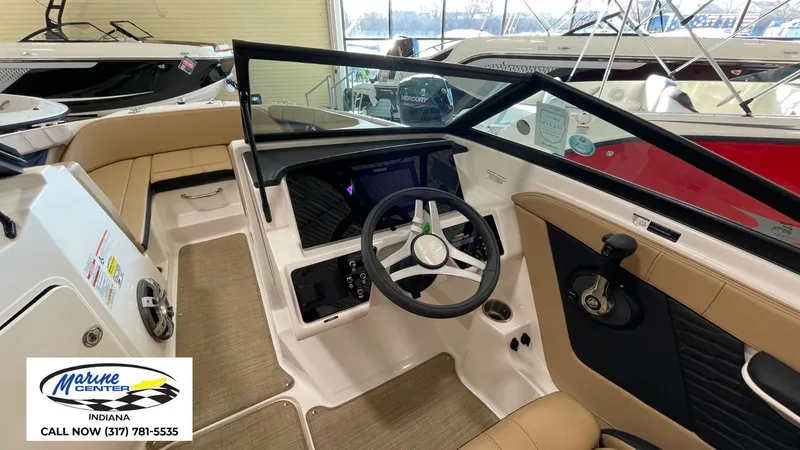 Slide: The Image of Interior view of 2023 Sea Ray SPX 190 boat with steering wheel and seating. - 19