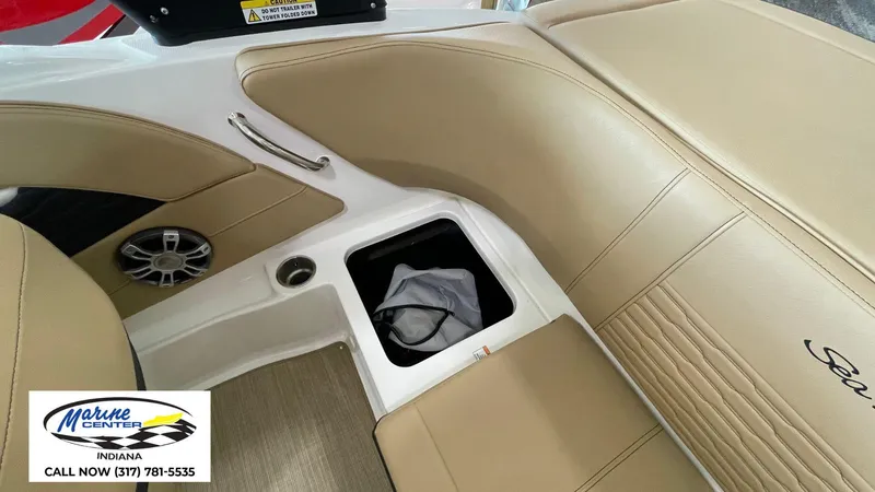 Slide: The Image of 2023 Sea Ray SPX 190 boat interior with tan seating and storage compartment. - 3