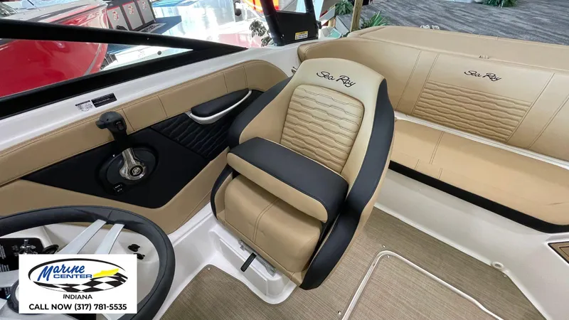 Slide: The Image of 2023 Sea Ray SPX 190 boat interior with tan and black seating, Marine Center contact info. - 4
