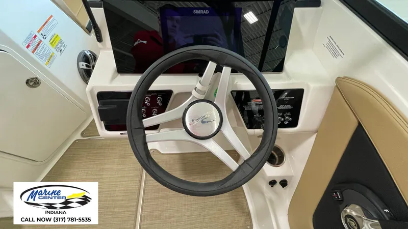 Slide: The Image of 2023 Sea Ray SPX 190 boat dashboard with steering wheel and control panel. - 7