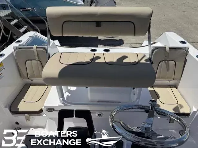 Slide: The Image of 2025 Yamaha Boats 222 FSH Sport interior with beige seating and steering wheel. - 4