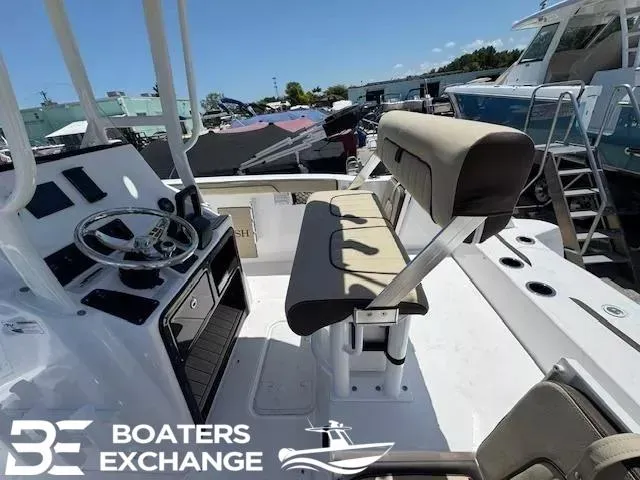Slide: The Image of 2025 Yamaha Boats 222 FSH Sport interior with helm and seating at Boaters Exchange. - 5