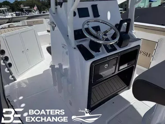 Slide: The Image of 2025 Yamaha Boats 222 FSH Sport dashboard with steering wheel and controls, Boaters Exchange logo. - 6