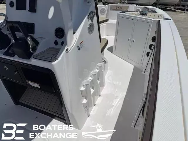 Slide: The Image of 2025 Yamaha Boats 222 FSH Sport interior with console and storage, showcased by Boaters Exchange. - 7