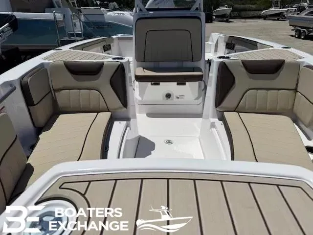 Slide: The Image of 2025 Yamaha Boats 222 FSH Sport interior with beige seating, showcased by Boaters Exchange. - 9