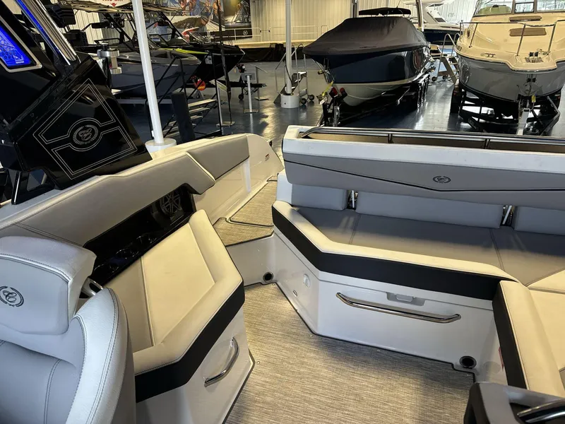Slide: The Image of Interior of 2025 Cobalt R4 Surf boat with luxurious seating in showroom. - 15