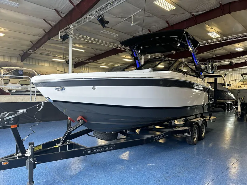 Slide: The Image of 2025 Cobalt R4 Surf boat on trailer in indoor showroom. - 3