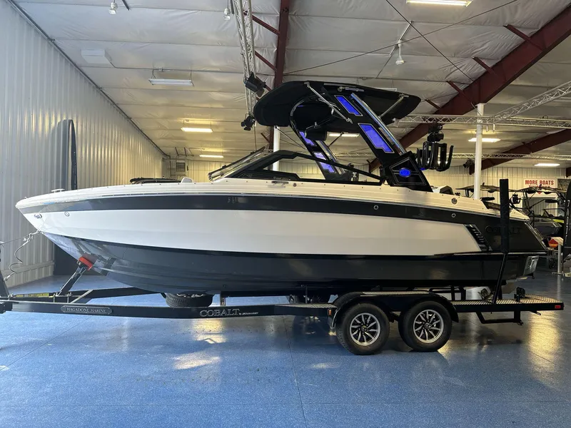 Slide: The Image of 2025 Cobalt R4 Surf boat on trailer in indoor showroom. - 4