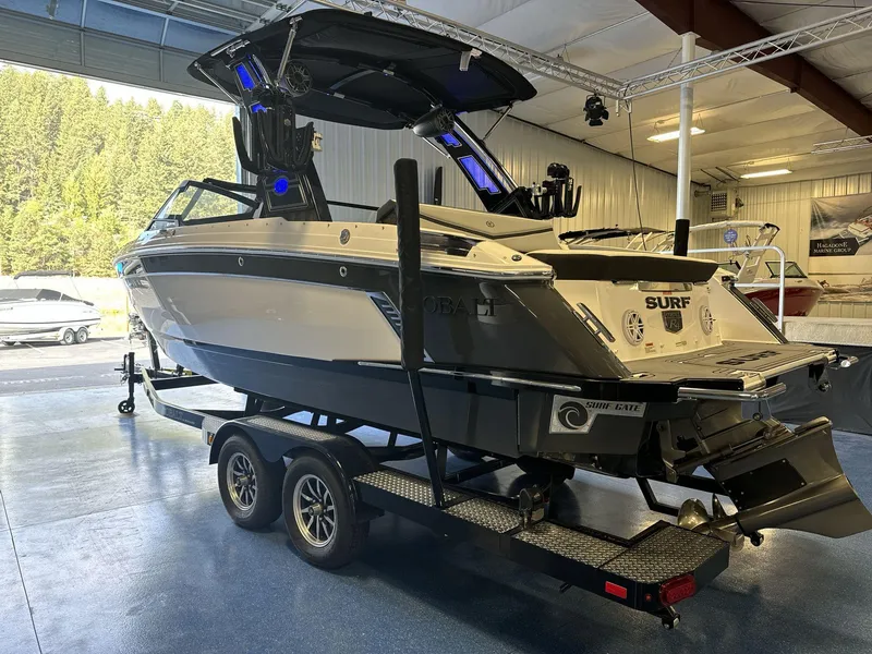 Slide: The Image of 2025 Cobalt R4 Surf boat on trailer in showroom, featuring sleek design and advanced surf technology. - 5