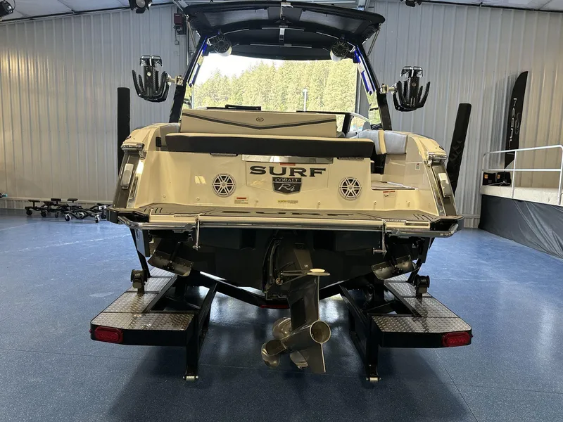 Slide: The Image of 2025 Cobalt R4 Surf boat in showroom, rear view with propeller and surf features. - 6