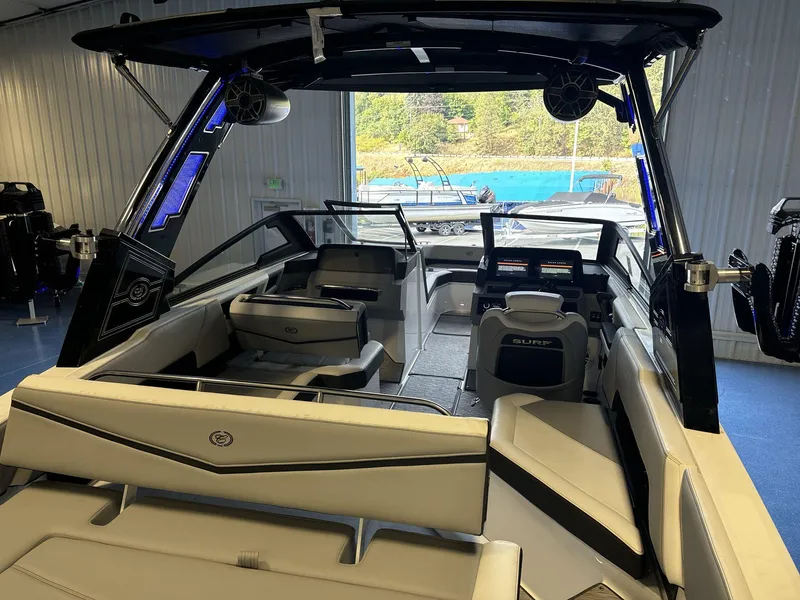 Slide: The Image of 2025 Cobalt R4 Surf boat interior with modern seating and dashboard in a showroom. - 8