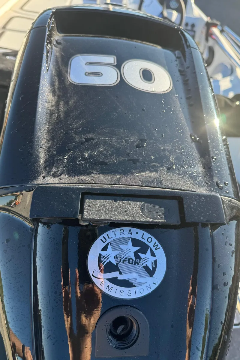 Slide: The Image of Bayliner 15E 2025 boat engine with 60 horsepower and ultra-low emissions label. - 10