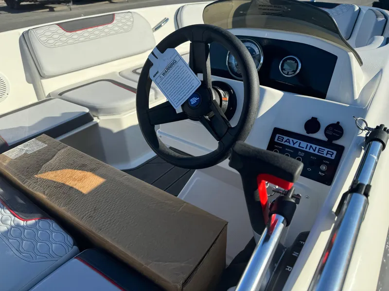 Slide: The Image of 2025 Bayliner 15E boat interior with steering wheel and dashboard controls. - 3