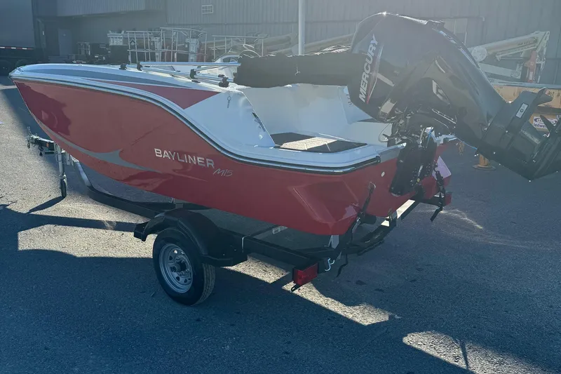 Slide: The Image of 2025 Bayliner 15E boat with Mercury engine on trailer, red and white design. - 5