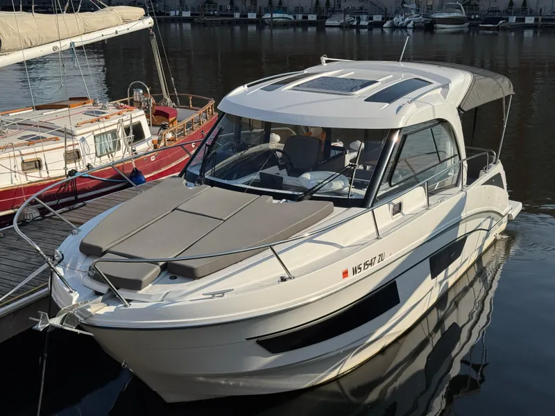 Slide: The Image of 2023 Beneteau Antares 9 boat docked in a marina, featuring sleek design and modern amenities. - 1