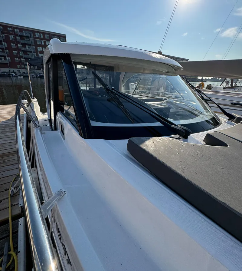 Slide: The Image of 2023 Beneteau Antares 9 docked at marina, showcasing sleek design and modern features. - 10