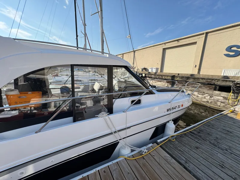 Slide: The Image of 2023 Beneteau Antares 9 docked at marina under clear blue sky. - 12