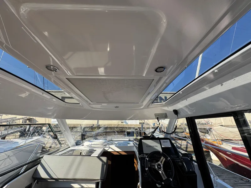 Slide: The Image of Interior view of 2023 Beneteau Antares 9 boat, featuring sleek design and modern controls. - 25